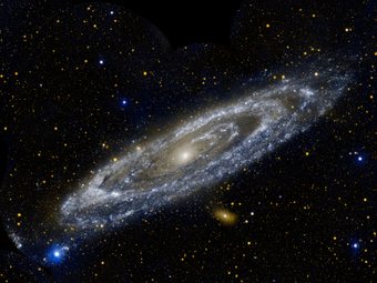 A typical spiral galaxy with stars and other galaxies visible in the far distance.