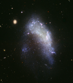 An irregularly shaped galaxy. The galaxy has no definite shape or pattern of brightness.