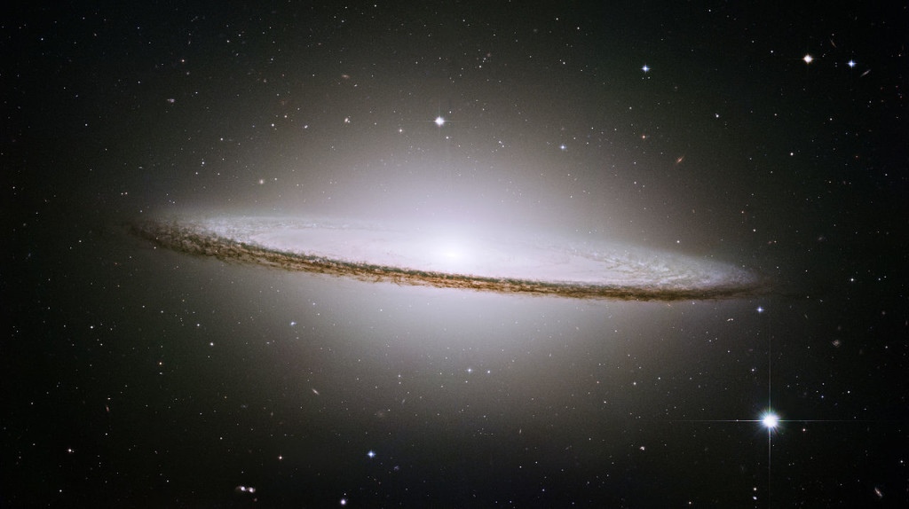 The famous Sombrero galaxy (M104) is a bright nearby spiral galaxy. The prominent dust lane and halo of stars and globular clusters give this galaxy its name. Something very energetic is going on in the Sombrero's center, as much X-ray light has been detected from it. This X-ray emission coupled with unusually high central stellar velocities cause many astronomers to speculate that a black hole lies at the Sombrero's center - a black hole a billion times the mass of our Sun.