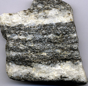 a rock sample with striping of white and black