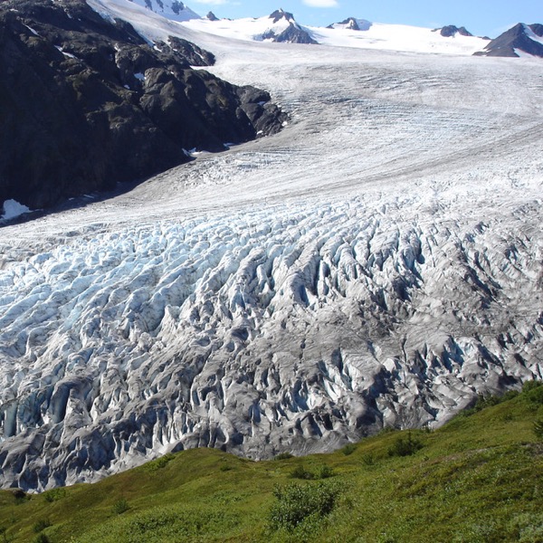 a glacier curving through a valley pass