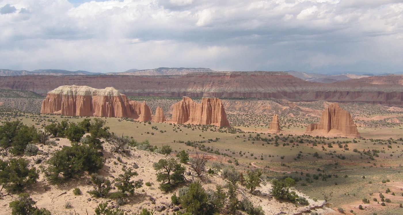 sandstone rock formations in a desert setting, with plateaus in the bckground