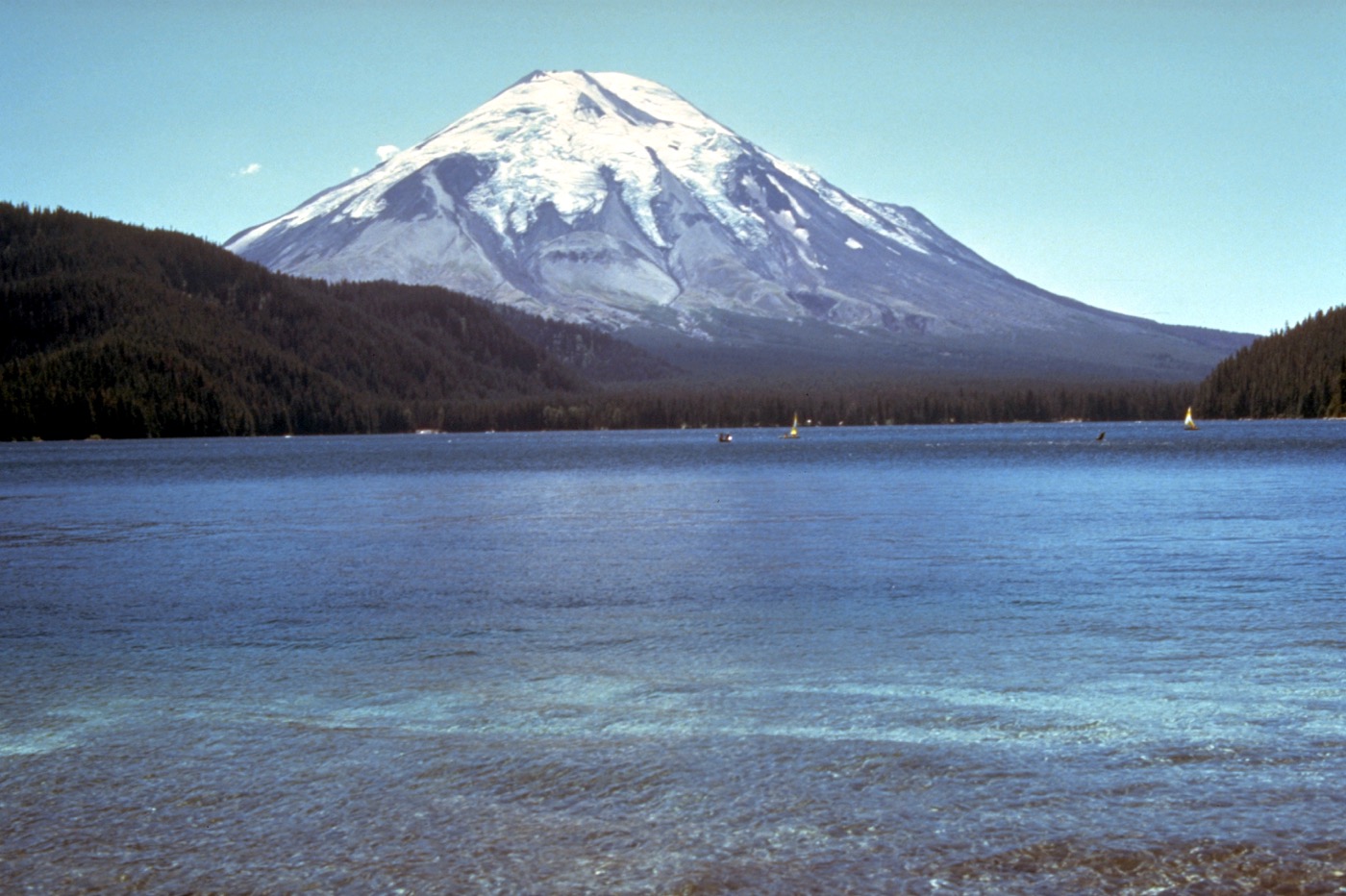 A large mountain with a lake in the foreground
