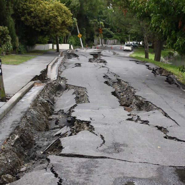 a long street with sinking cracks running along the asphalt
