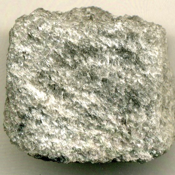 a white and gray rock with a frothy appearance