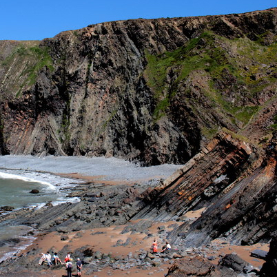 A cliff along side a bay showing visible folding and erosion
