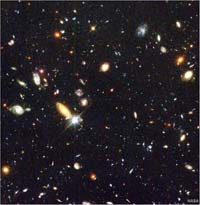 A field of possibly hundreds of galaxies in a distant region of the night sky.