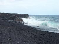 Surging waves on a Hawaii black sand beach