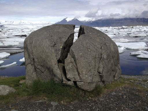 Boulder of igneous rock from Iceland displaying the effects of physical weathering. Image credit to Bridget Wade from: https://www.flickr.com/photos/uclmaps/39083969255 CC BY 2.0 Attribution