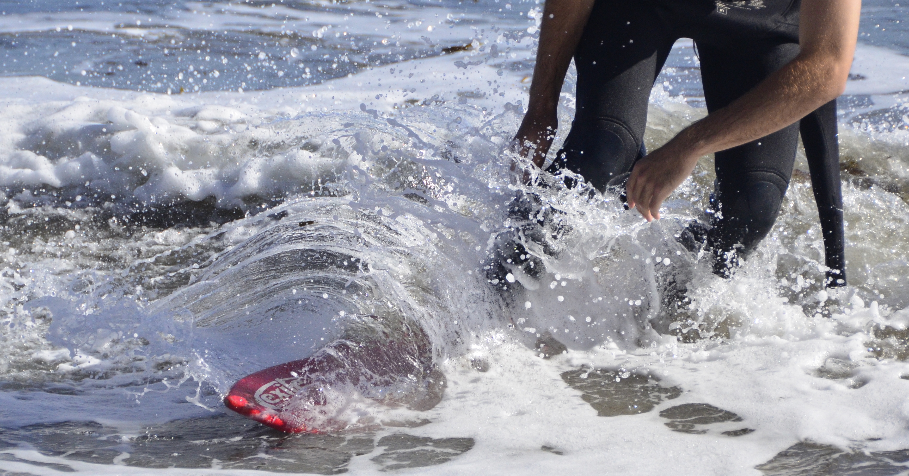 Closeup of a surfer riding a breaking wave