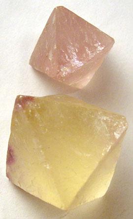 Two fluorite crystals that are octahedrons--two square-based pyramids joined at the bases.
