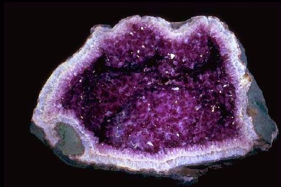 The rock is hollow and filled with purple quartz crystals.