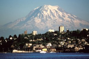 The mountain is very tall, and looms over the city