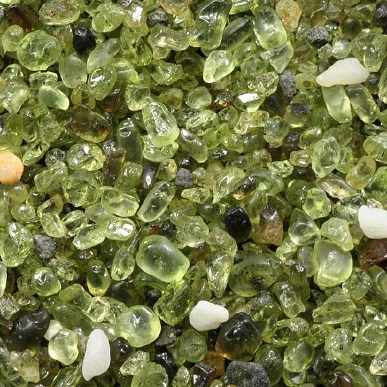 Close-up of rounded green sand grains.