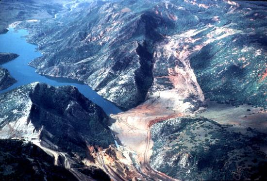 Massive landslide flows through the center of the photo. A river terminates at the landslide on the left.