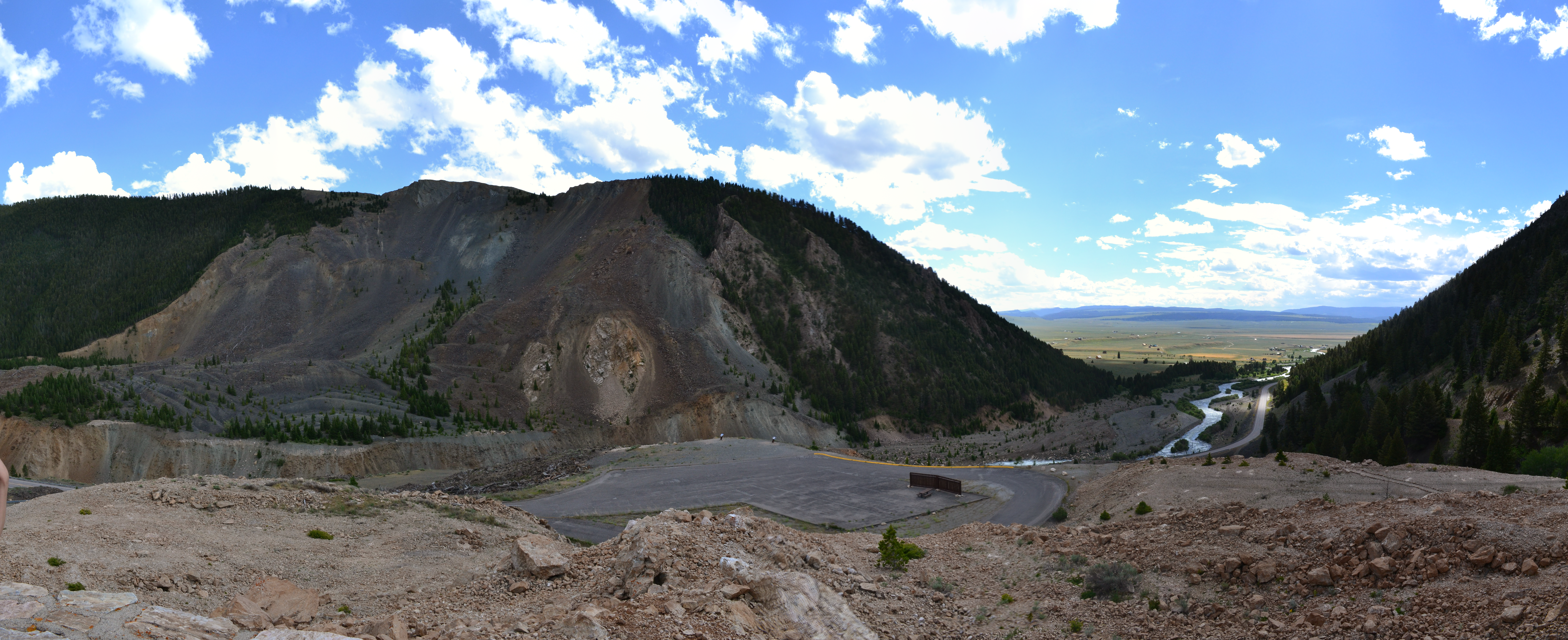 Photo looking at a mountain covered by loose rocks, taken from a high point of loose rocks across the mountain.