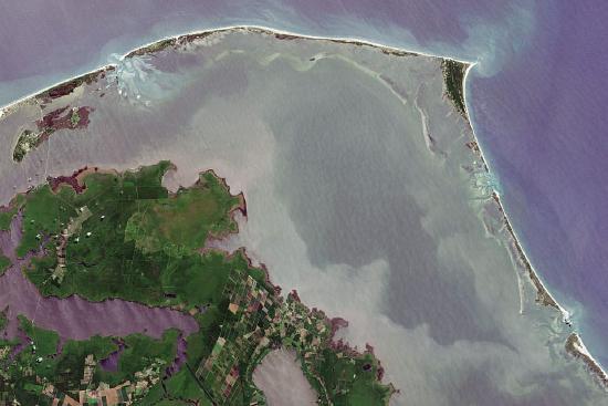 There is a thin strip of land with beaches off the mainland.