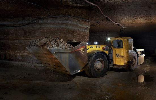 Bulldozer moves rock underground.