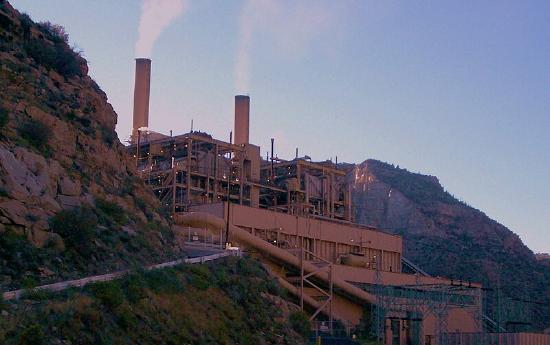 The power plant has smoke coming from it