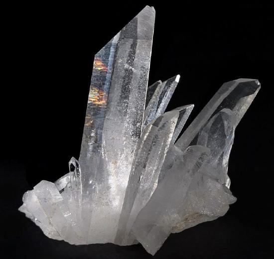 A mass of quartz crystals showing typical six sided habit with points