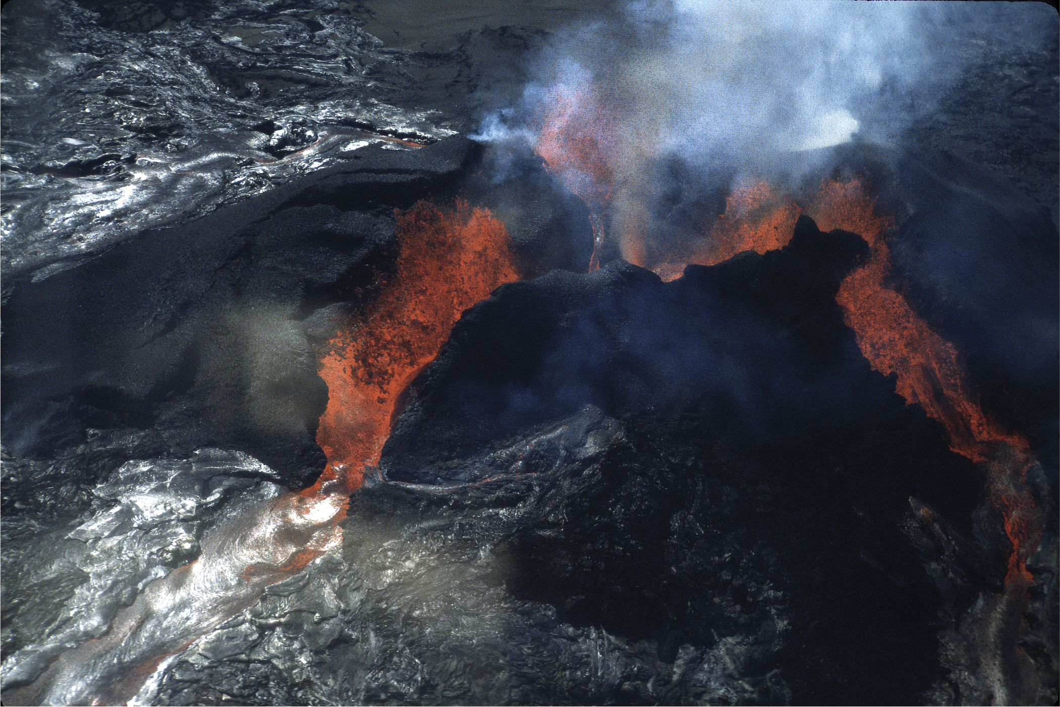 Lava flowing down black rocks