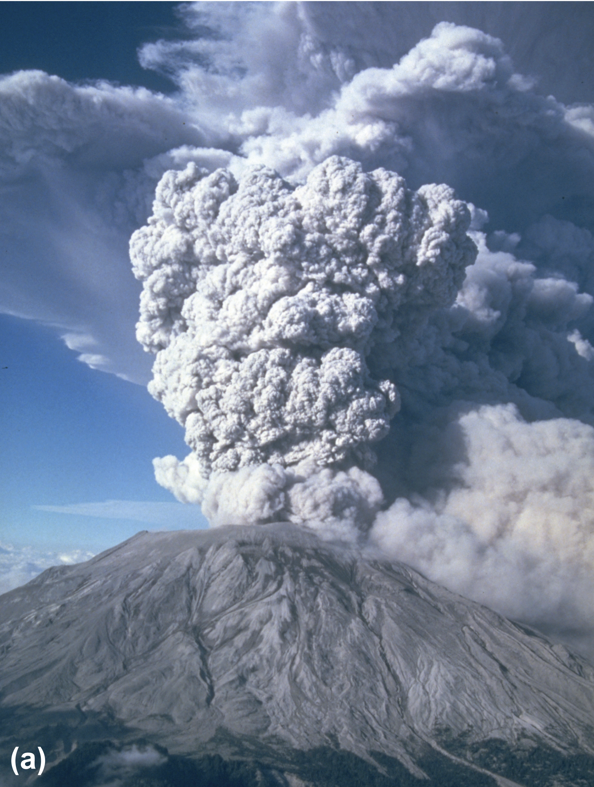 A volcano erupting a cloud of ash