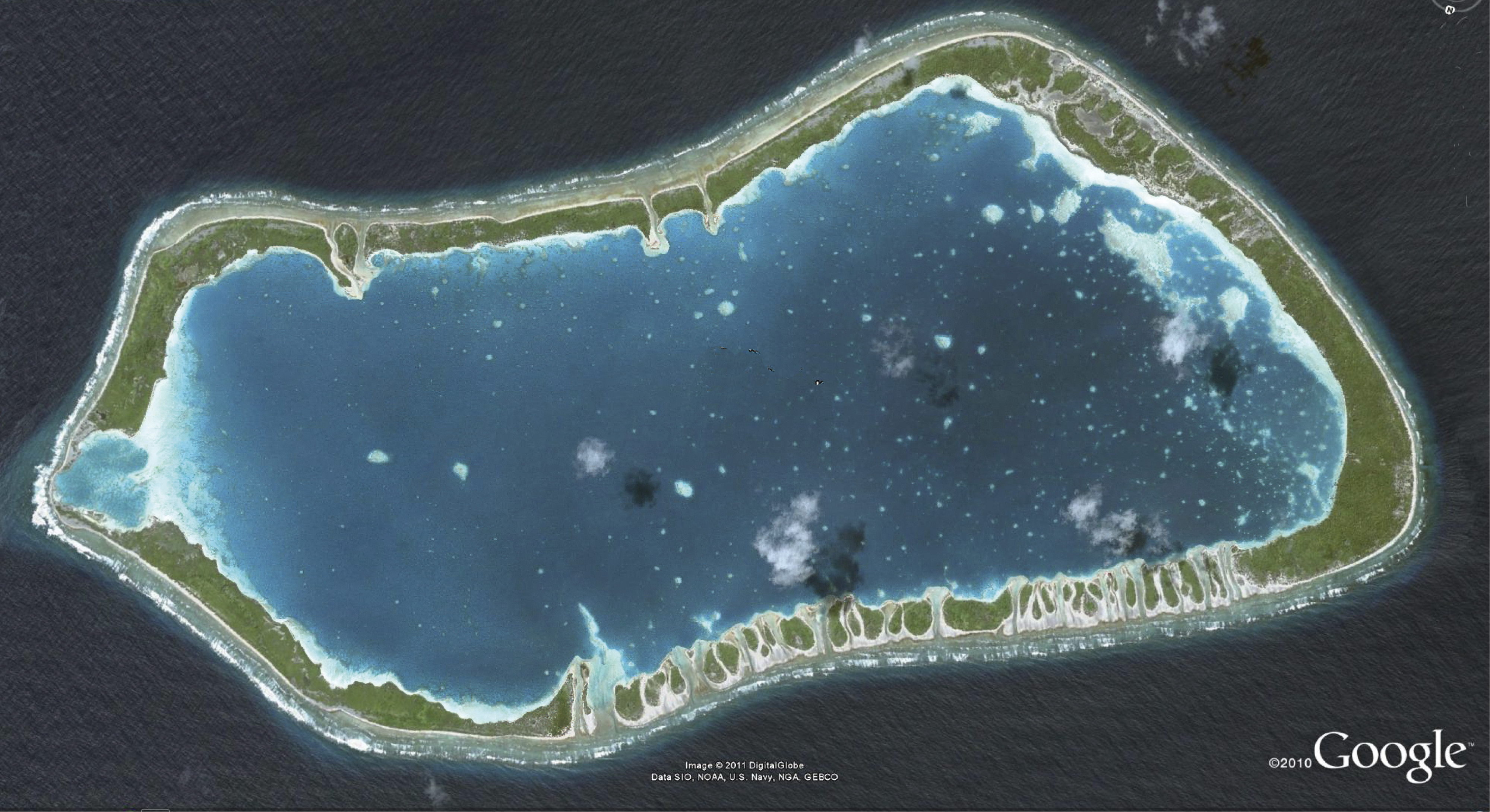 The ocean with a green irregularly shaped oval and lighter water in the middle