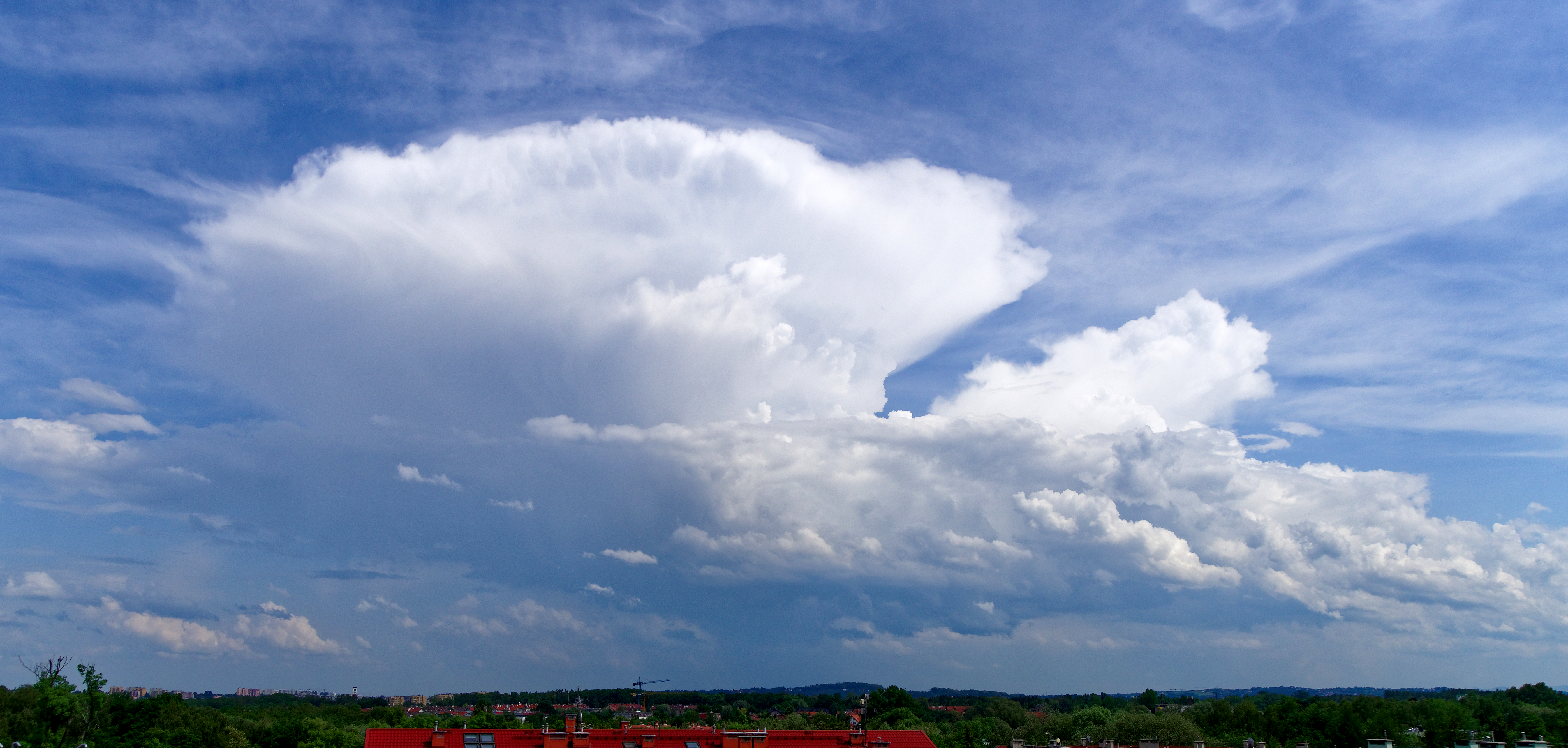A massive cloud that is flat and dark at the bottom, rising into fluffy white columns.