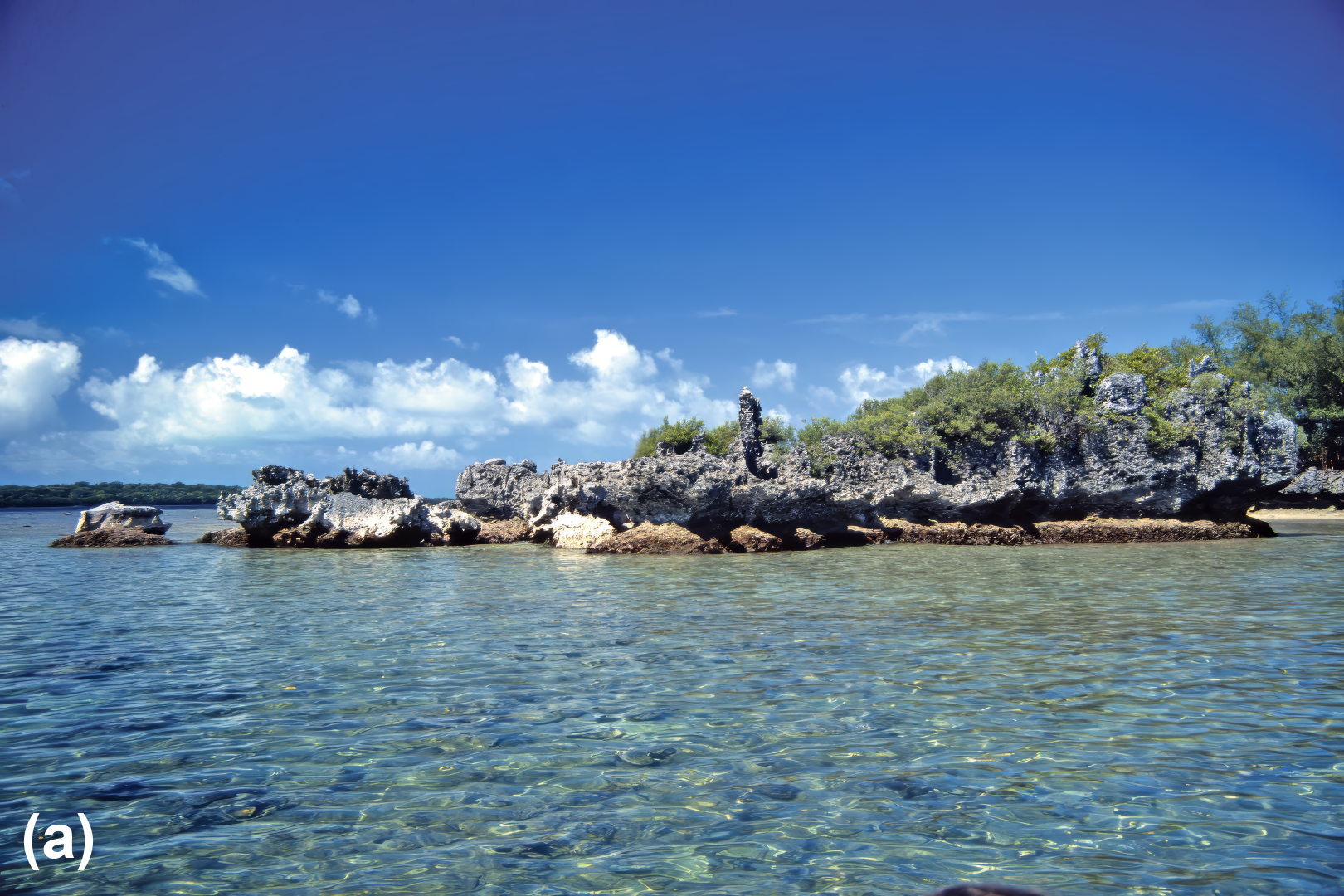Rocky formations in a beach seen from the water