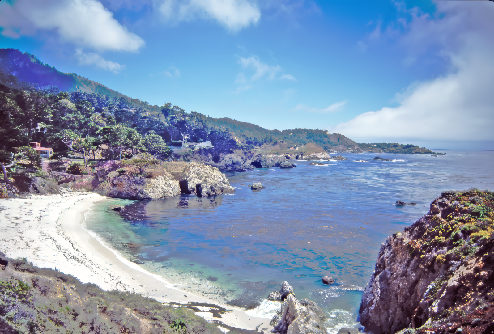 Sandy cove surrounded by rocks and trees