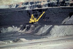 A large machine is removing coal.