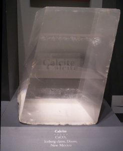 Calcite crystal in a shape called a rhomb like a cube squahed over toward one corner