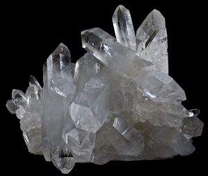 A mass of quartz crystals showing typical six sided habit with points