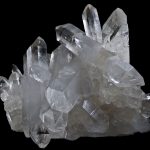 A mass of quartz crystals showing typical six sided habit with points