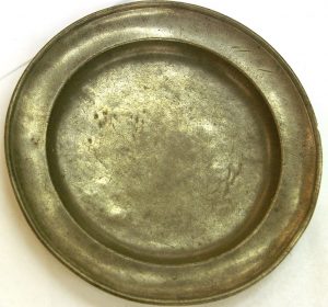 Antique pewter plate showing a more dull submetallic luster