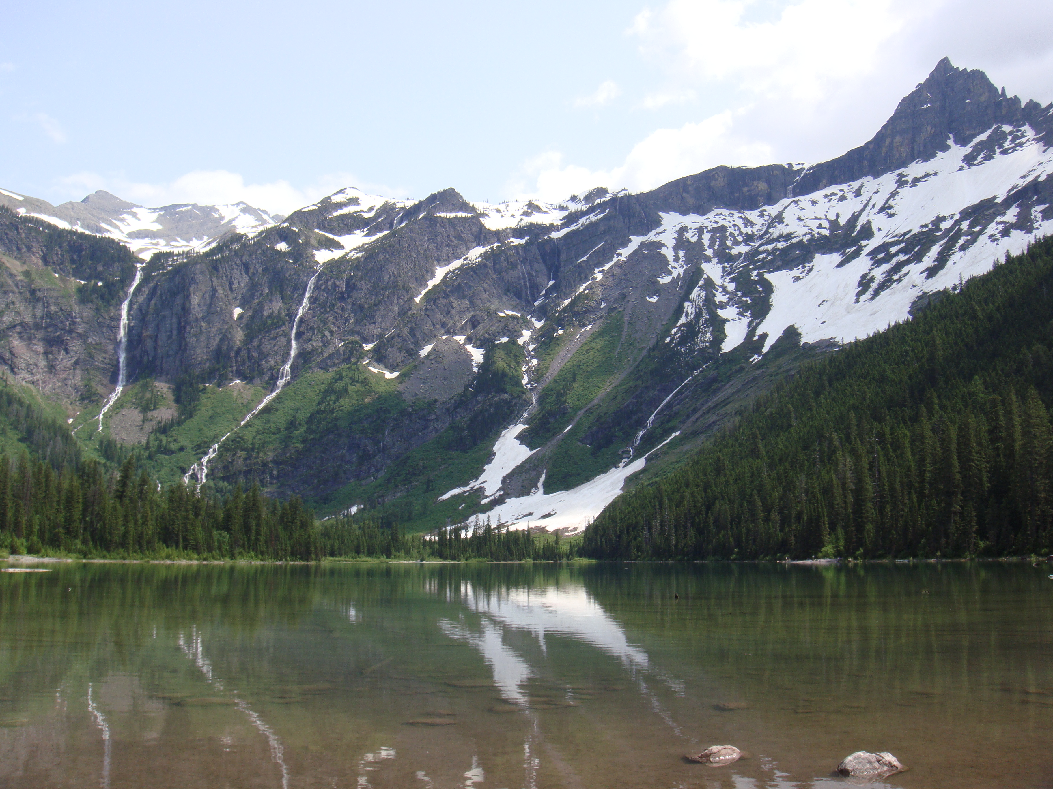 The valley is circular and filled with a lake.