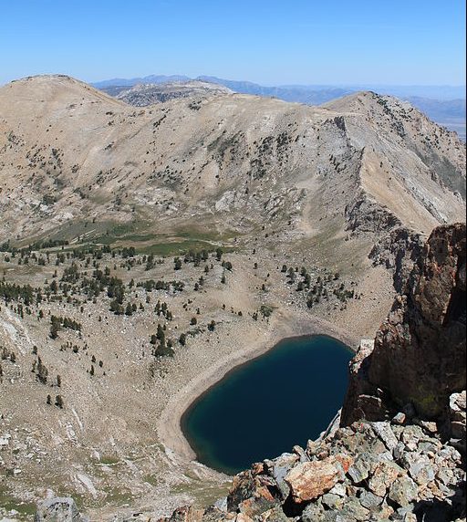 A mountainous area with a circular bowl filled with a lake.