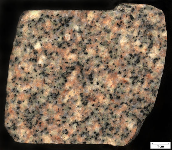 Photograph of cut granite. showing a variety of visible minerals, including quartz and k-feldspar.