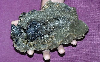 Reticulite is a type of pumice that only forms during eruption of basalt lava by vigorous lava fountains. It consists of fragile volcanic glass that has cooled incompletely around the walls of gas bubbles. The bubbles formed during the "explosive" eruption of basalt lava. The porosity of reticulite can reach 98 percent -- so high that reticulite sinks in water.