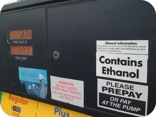 Gas pump with information on Ethanol gas. Sign reads as follows: "Contains Ethanol. Ethanol information. This product may contain up to 10% ethanol by volume. Additional information about ethanol blended gasoline may be found inside."