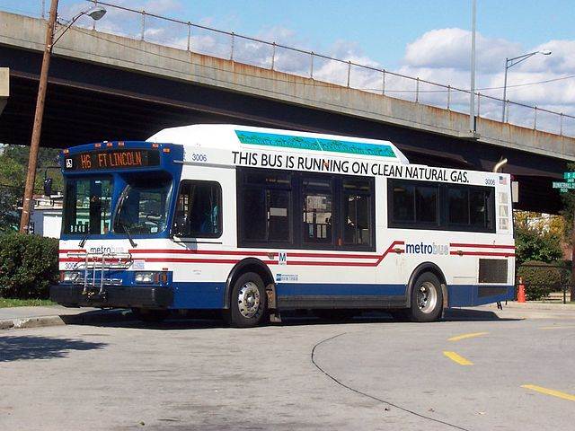 There is a banner on the side of the bus reading "This Bus is running on clean natural gas"